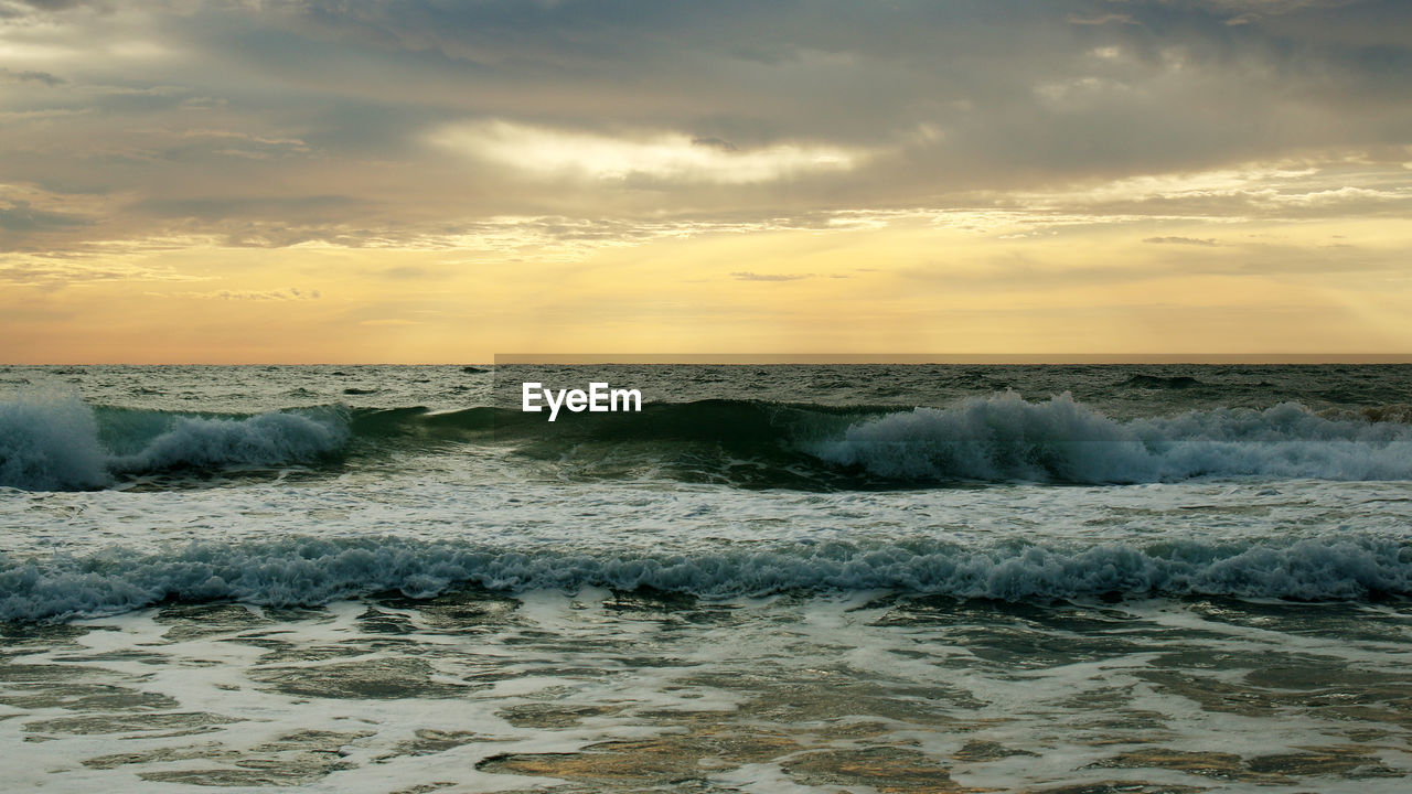 Beautiful sunset on the beach. the surf pounds the shore. phuket, thailand