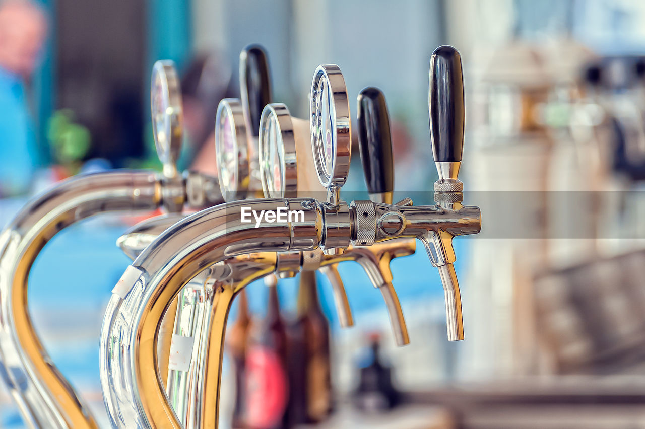 Close-up of beer taps in bar