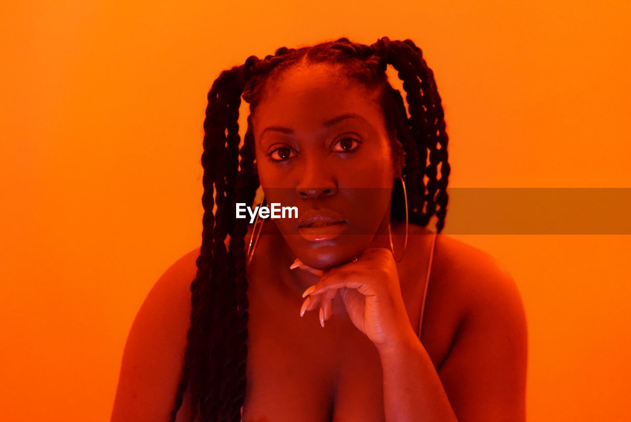 Black woman braids in orange 