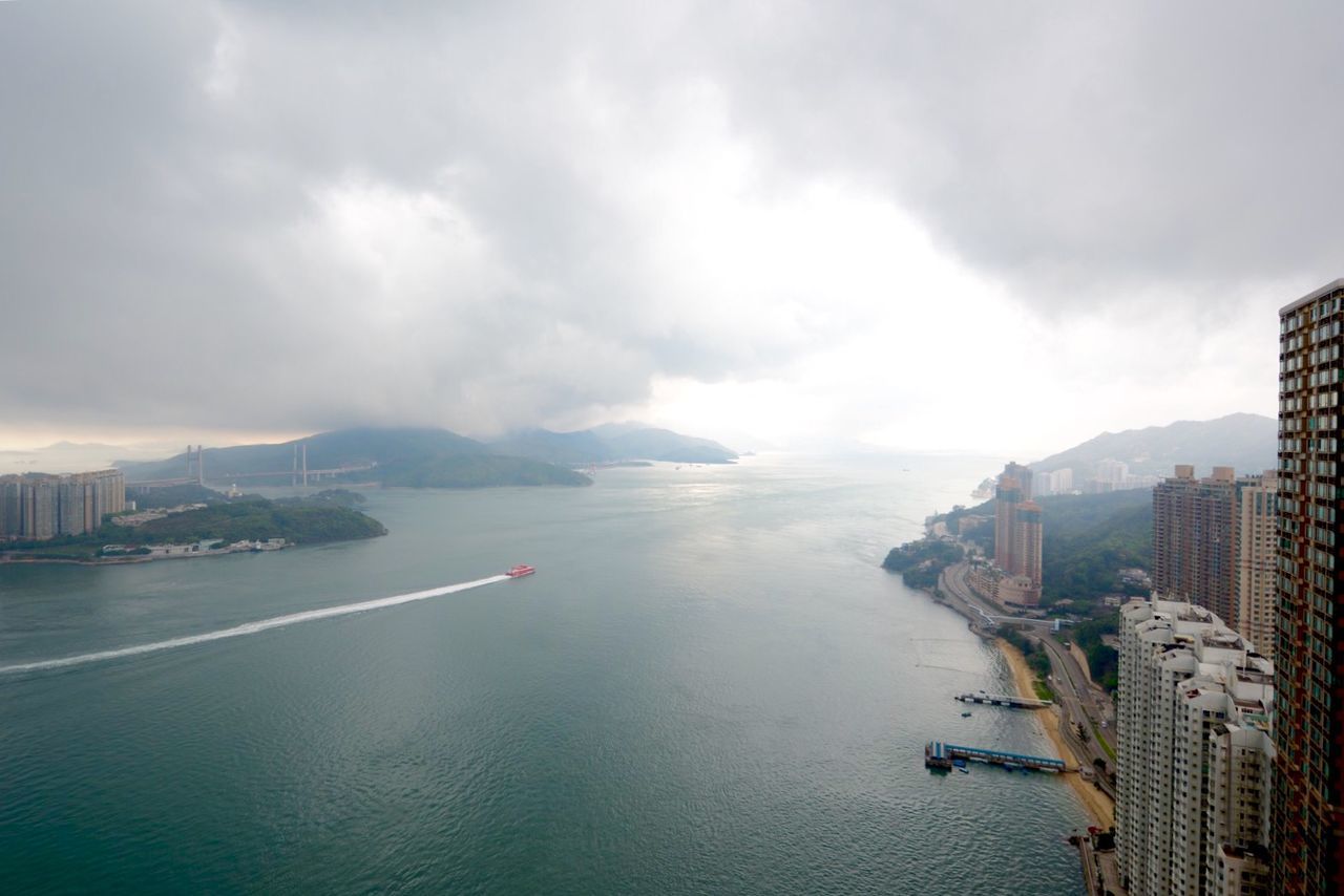 Panoramic view of city against cloudy sky