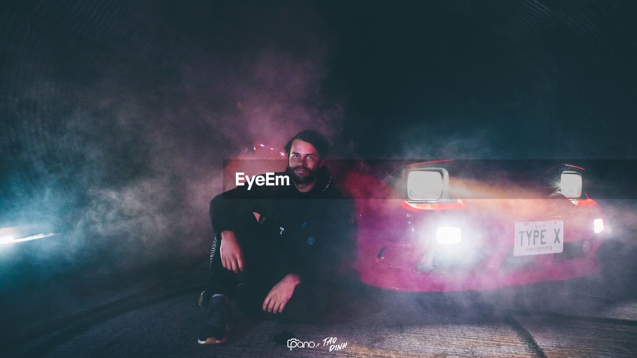 MAN IN ILLUMINATED CAR