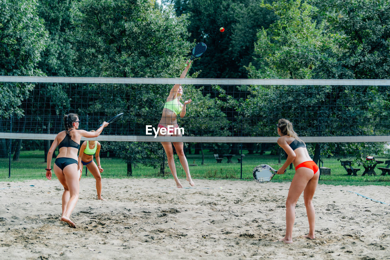 Beach tennis players at the net