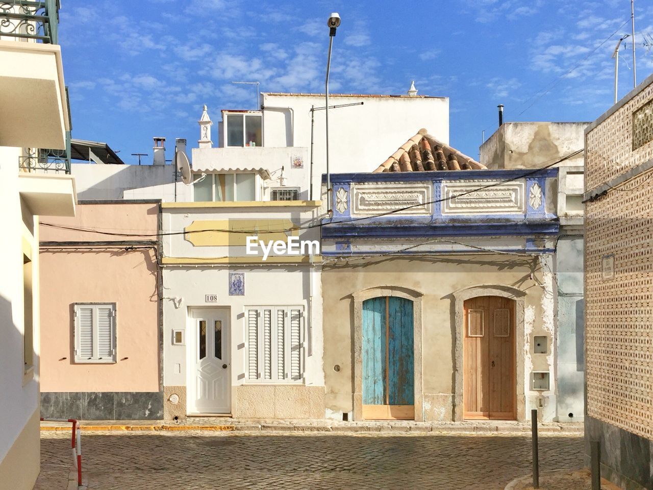 Exterior of buildings in town against sky