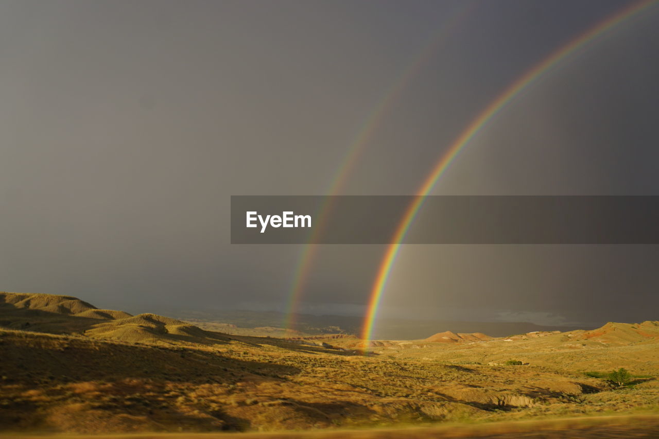 Rainbow over mountain against sky