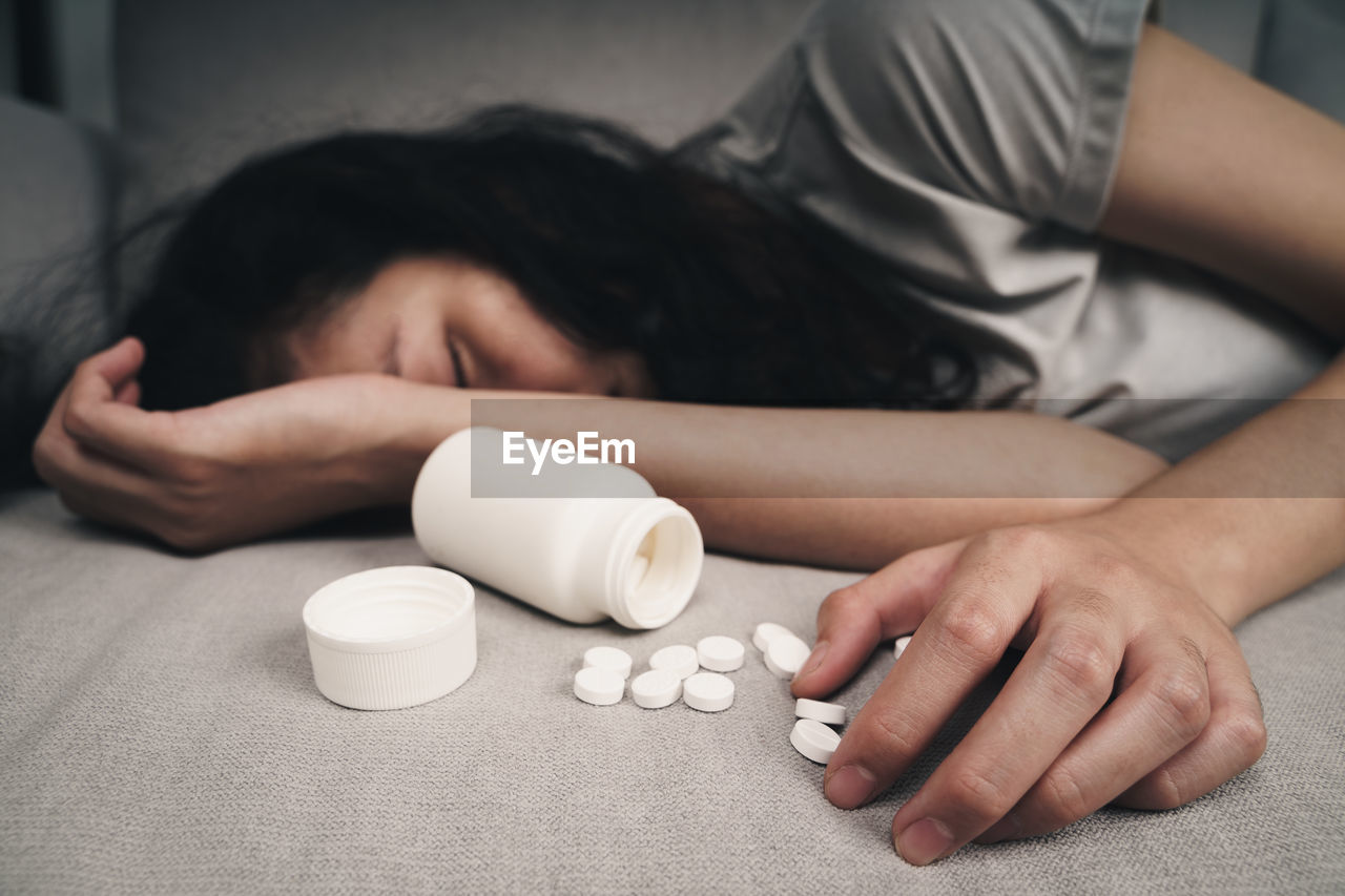 MIDSECTION OF A WOMAN SLEEPING ON TABLE