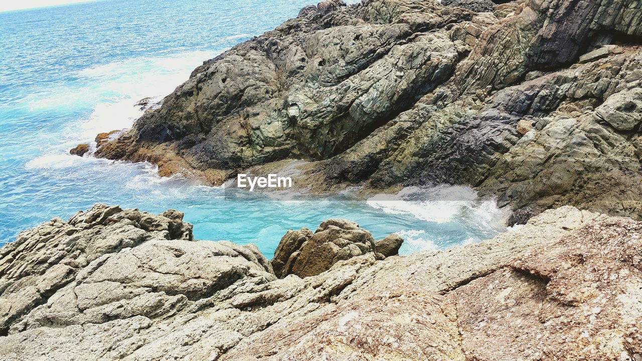 High angle view of sea water and rock formation in the bubbly pool