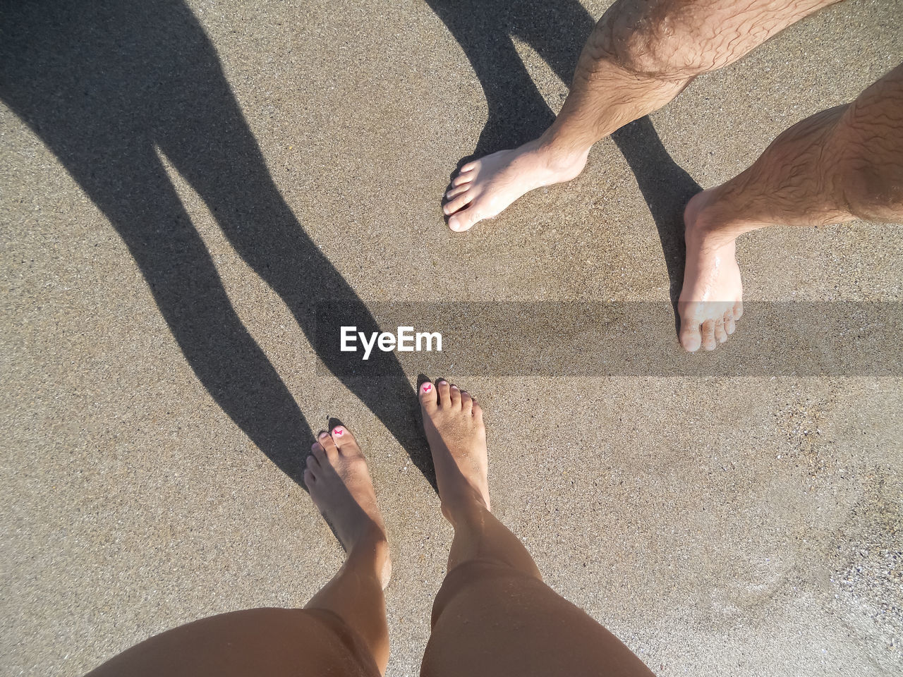 LOW SECTION OF PEOPLE LEGS ON SHADOW