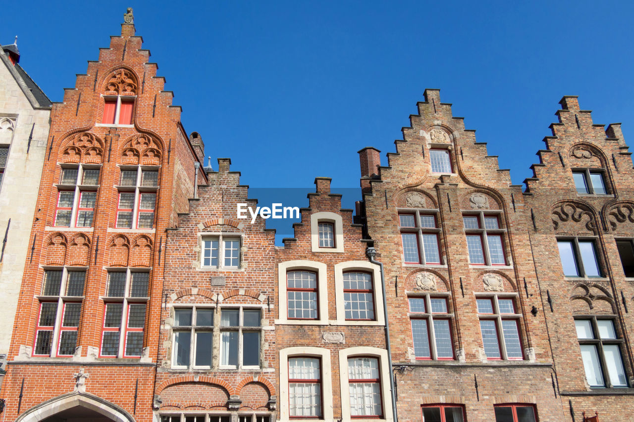 Low angle view of buildings against blue sky