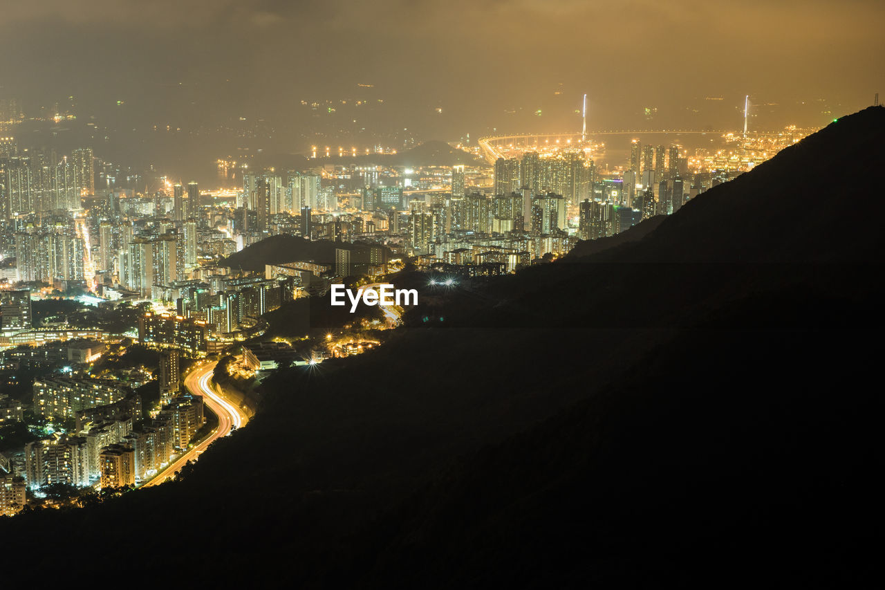 High angle view of illuminated buildings in city at night