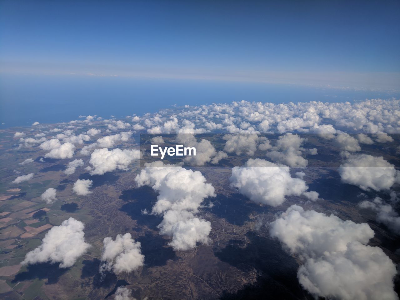 HIGH ANGLE VIEW OF CLOUDS OVER SEA