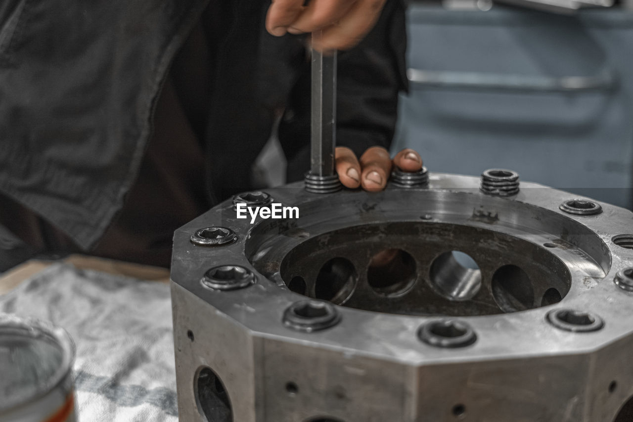 Close-up of man working on metal