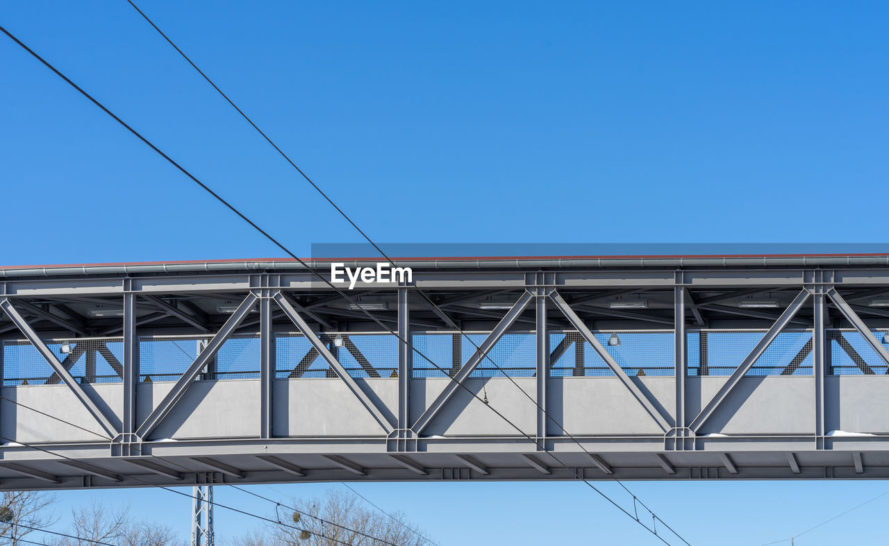 Low angle view of bridge against clear blue sky