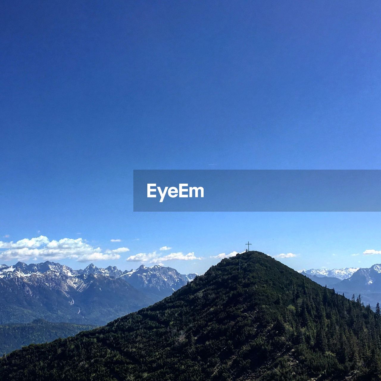 Scenic view of mountains against blue sky