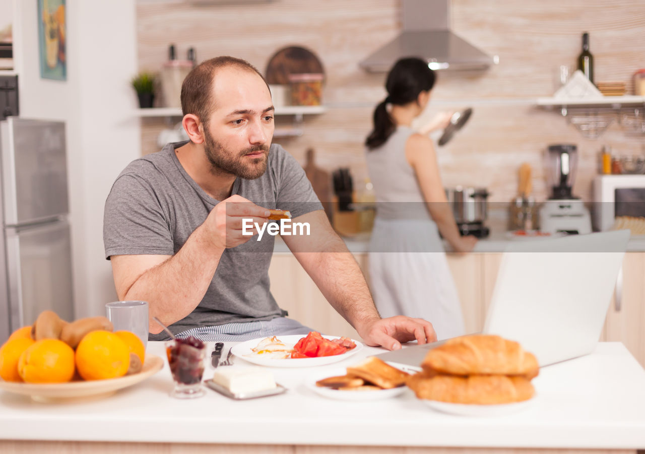 Friends standing on table at home