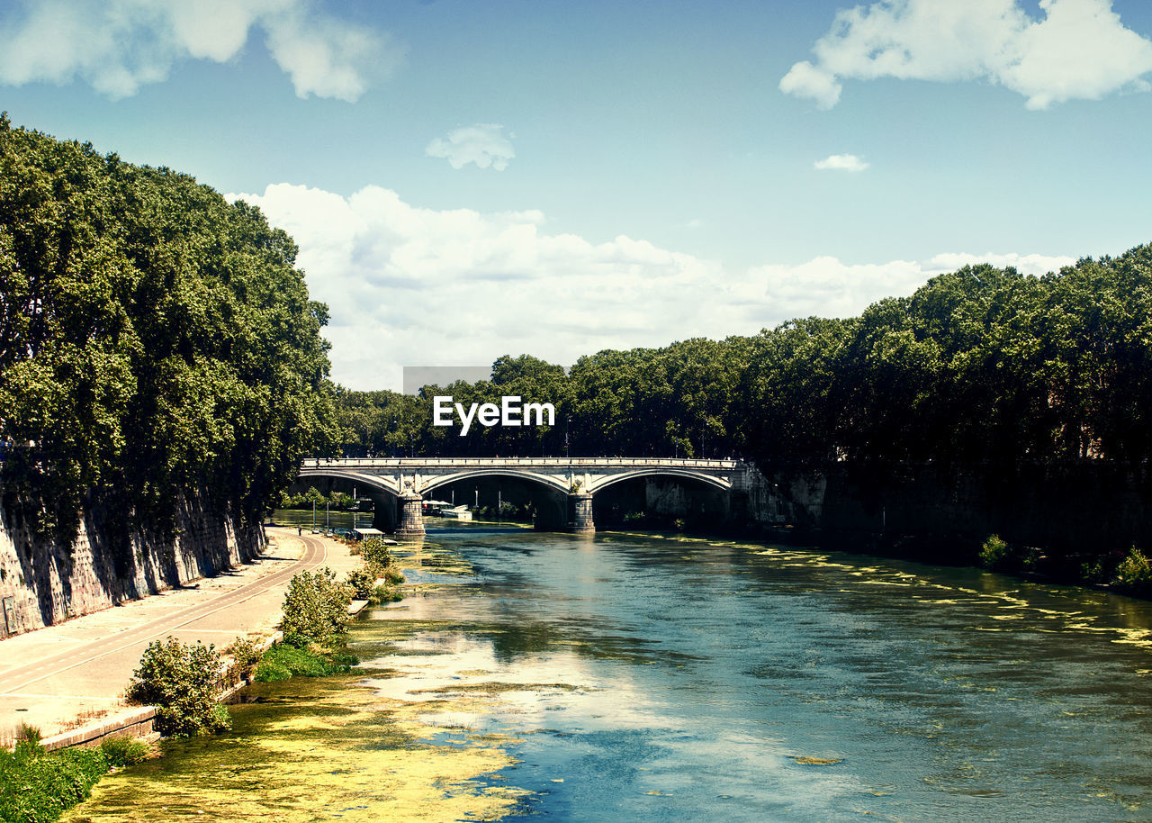 river, bridge, water, tree, nature, plant, reflection, sky, architecture, built structure, body of water, cloud, arch bridge, waterway, transportation, no people, arch, landscape, environment, autumn, reservoir, outdoors, day, travel destinations, rural area, scenics - nature, morning, beauty in nature, travel, tranquility, sunlight