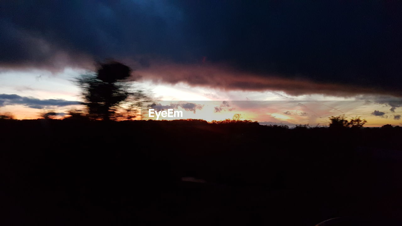 SILHOUETTE LANDSCAPE AGAINST DRAMATIC SKY