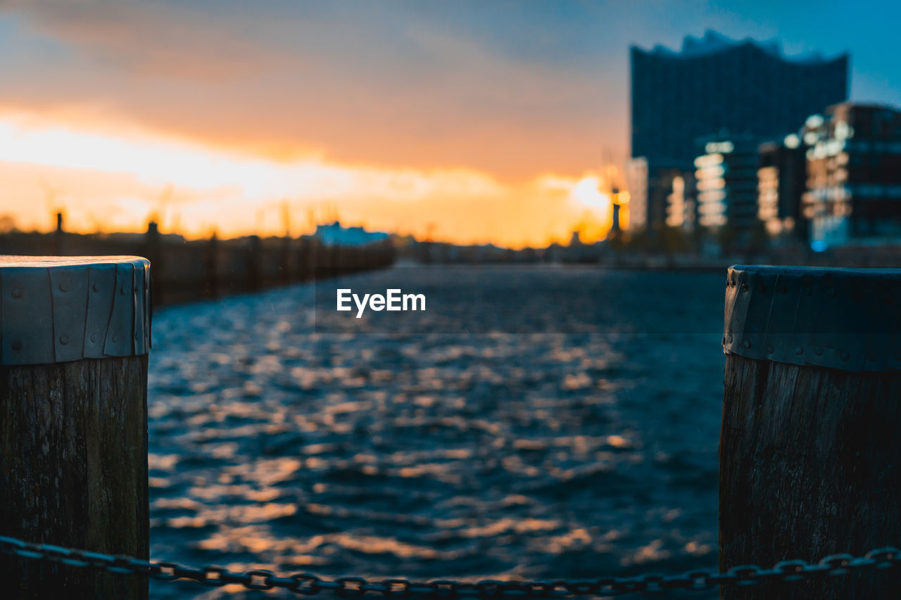 Close-up of wooden post against sky during sunset