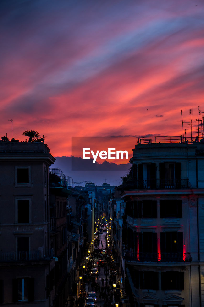 ILLUMINATED BUILDINGS AGAINST SKY DURING SUNSET