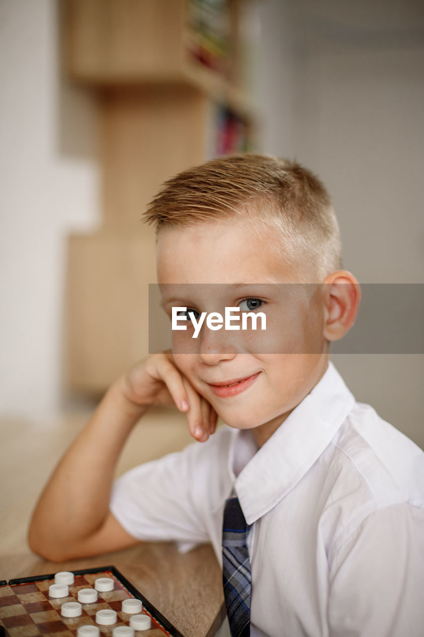 portrait of young man using laptop at home