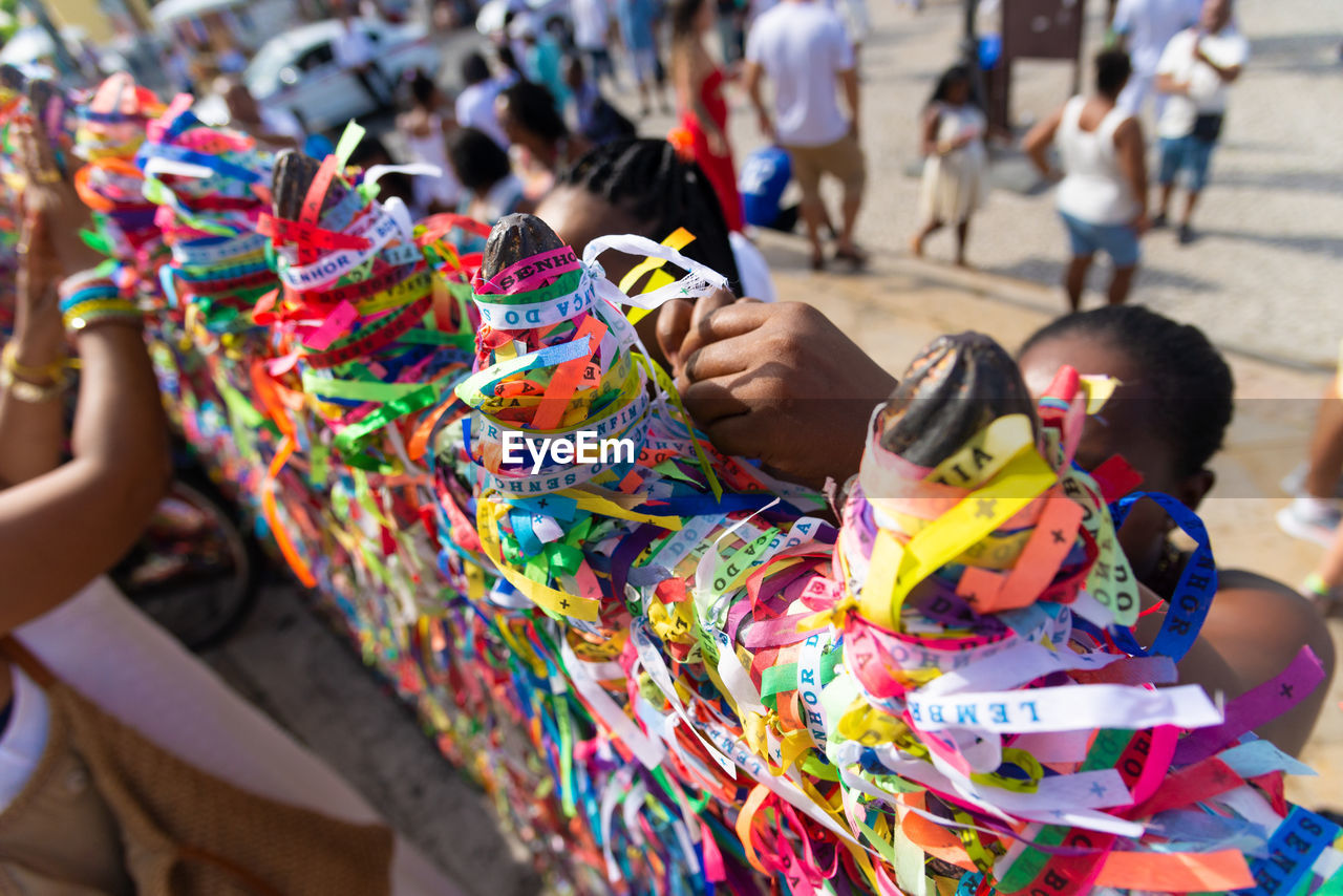 multi colored, group of people, festival, carnival, adult, women, tradition, crowd, celebration, day, person, men, outdoors, focus on foreground, event, clothing, city, street, arts culture and entertainment