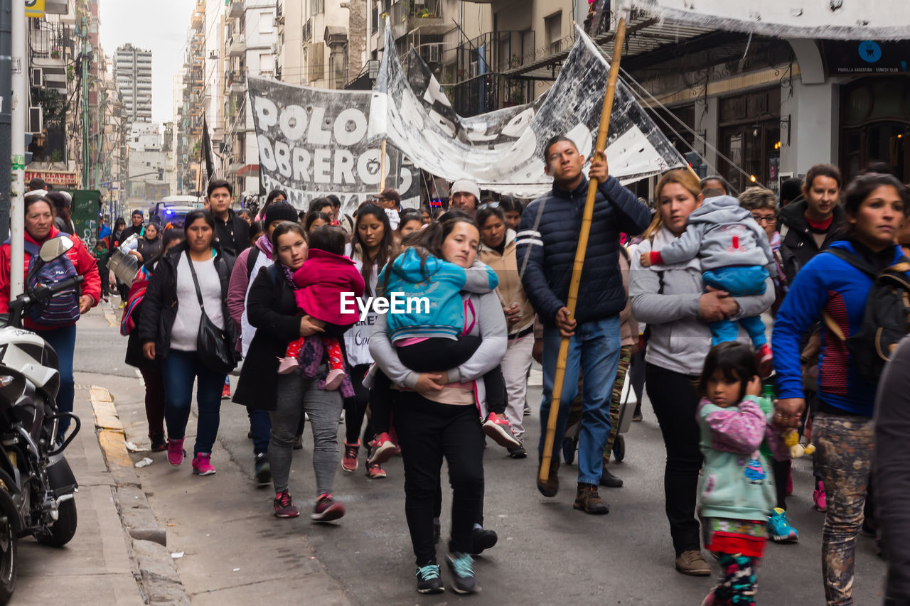 GROUP OF PEOPLE WALKING ON STREET