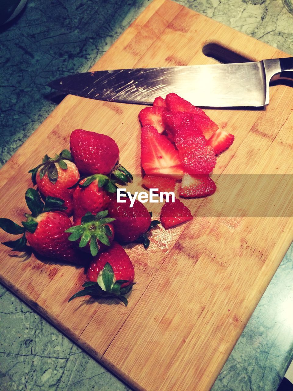 Strawberries on cutting board with knife