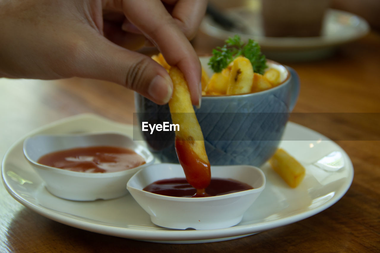 Close-up of person preparing food in bowl