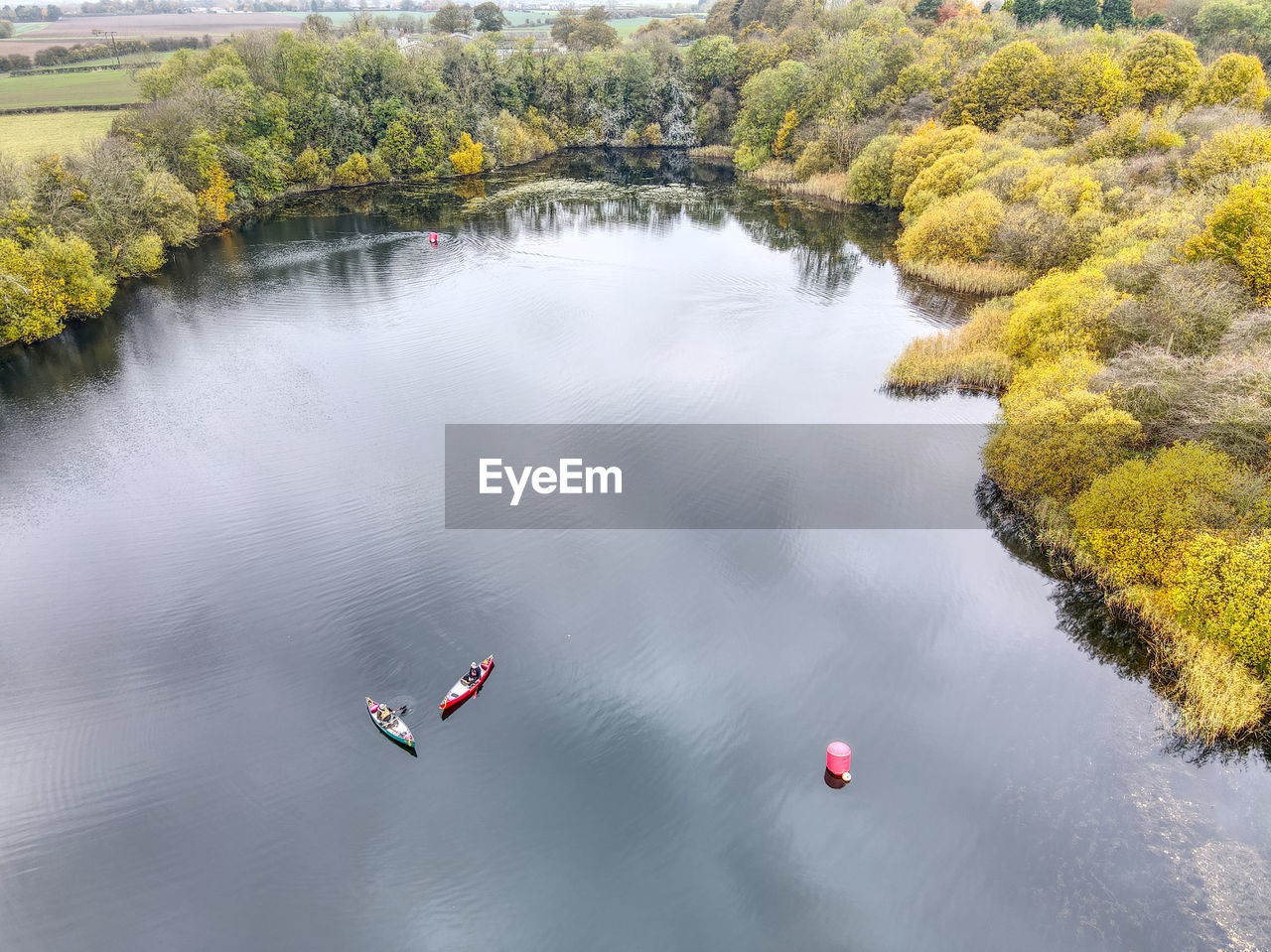 HIGH ANGLE VIEW OF LAKE AGAINST TREES