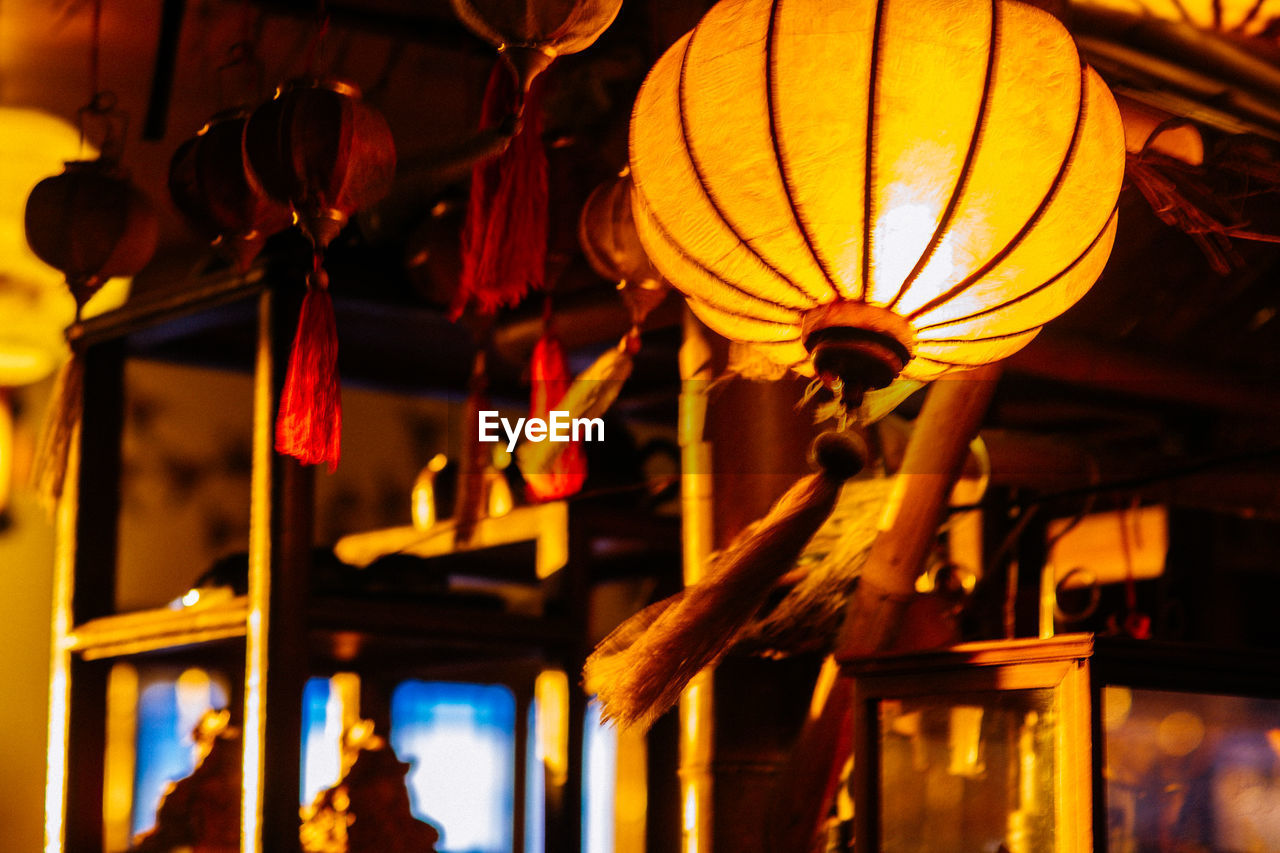 LOW ANGLE VIEW OF LANTERN HANGING ON CEILING