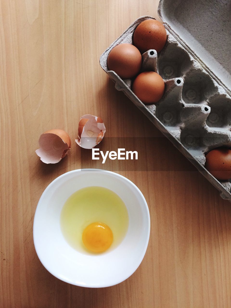 High angle view of eggs and bowl on table