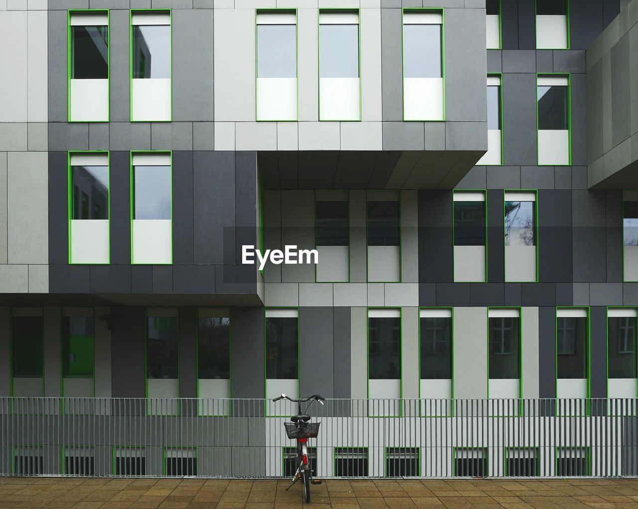 Bicycle parked in front of modern building