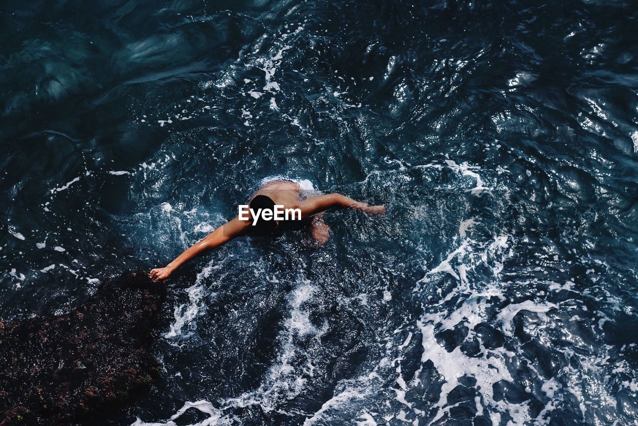 High angle view of man swimming in sea