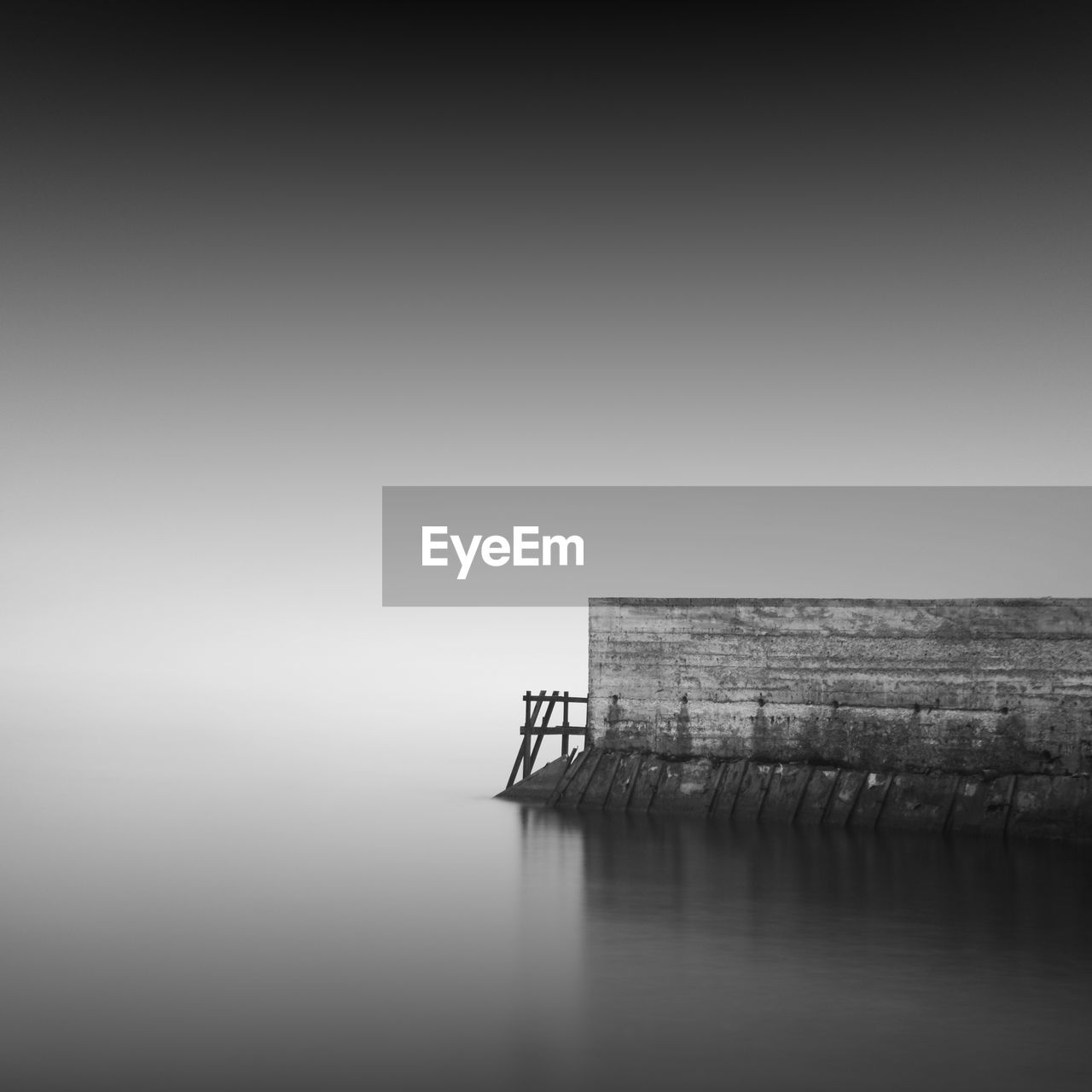 Pier by sea against sky during foggy weather