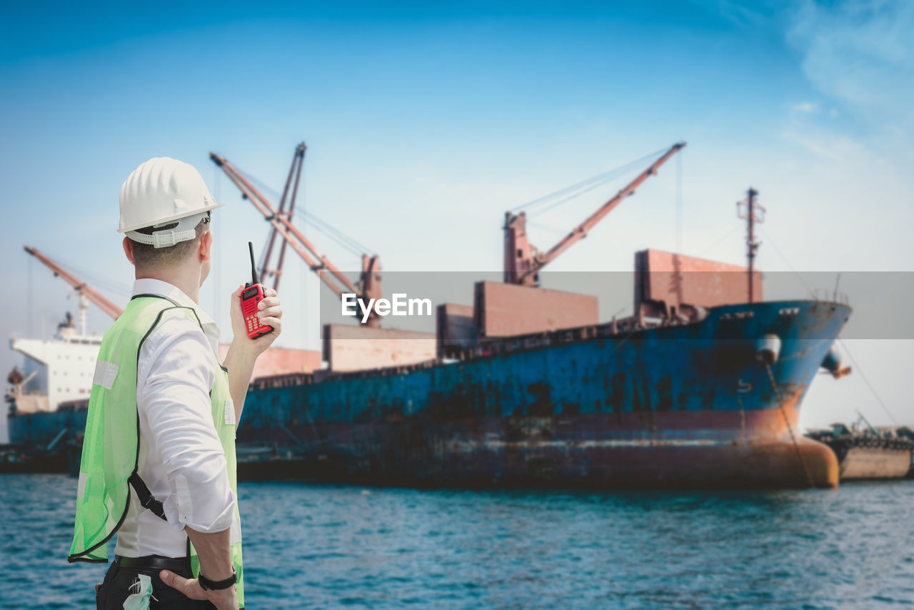 MAN STANDING ON SHIP