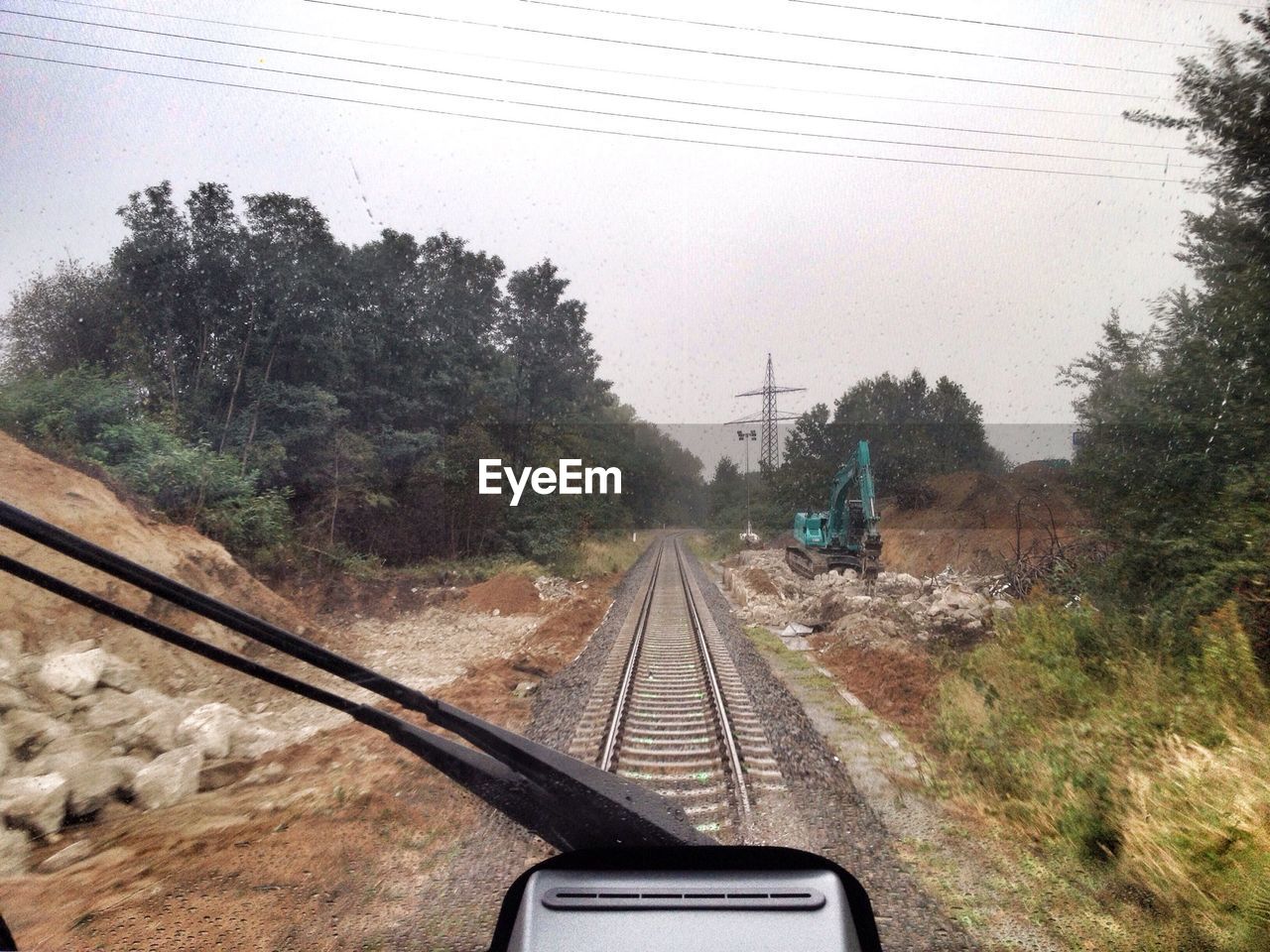 Cropped image of train on railroad track against sky