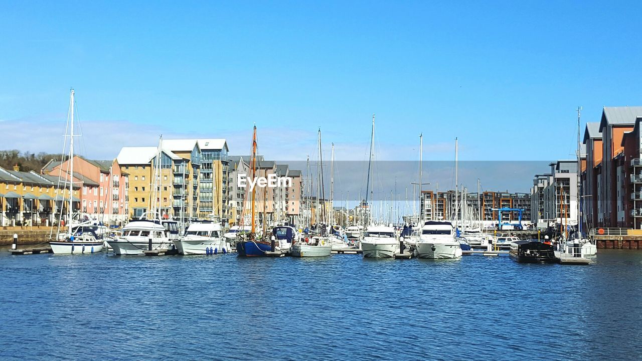 Boats moored at harbor