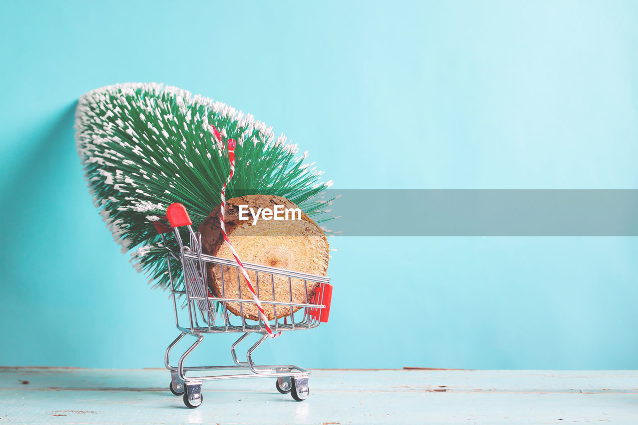 Decoration against wall in toy shopping cart