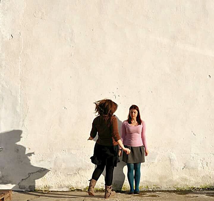 WOMAN STANDING ON WALL