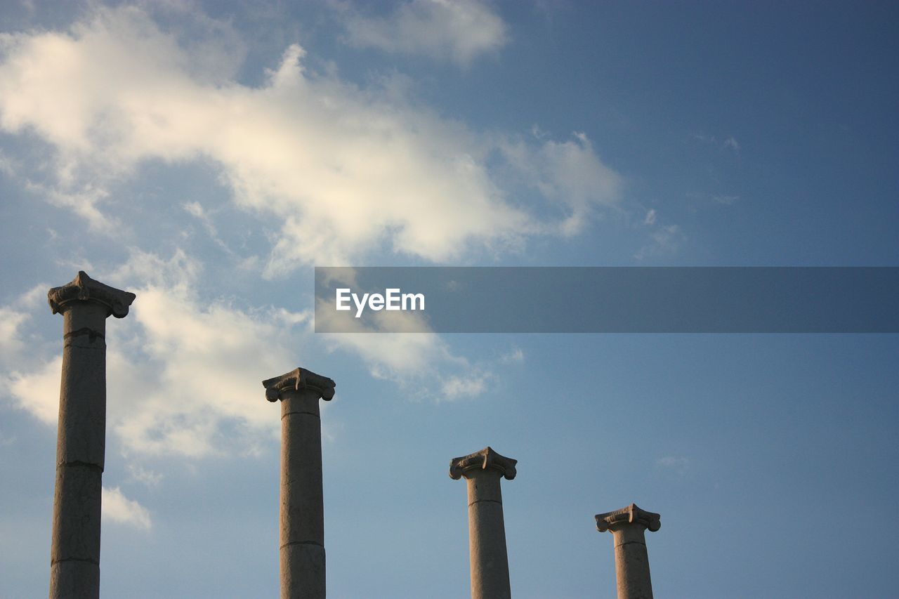 Low angle view of columns against blue sky