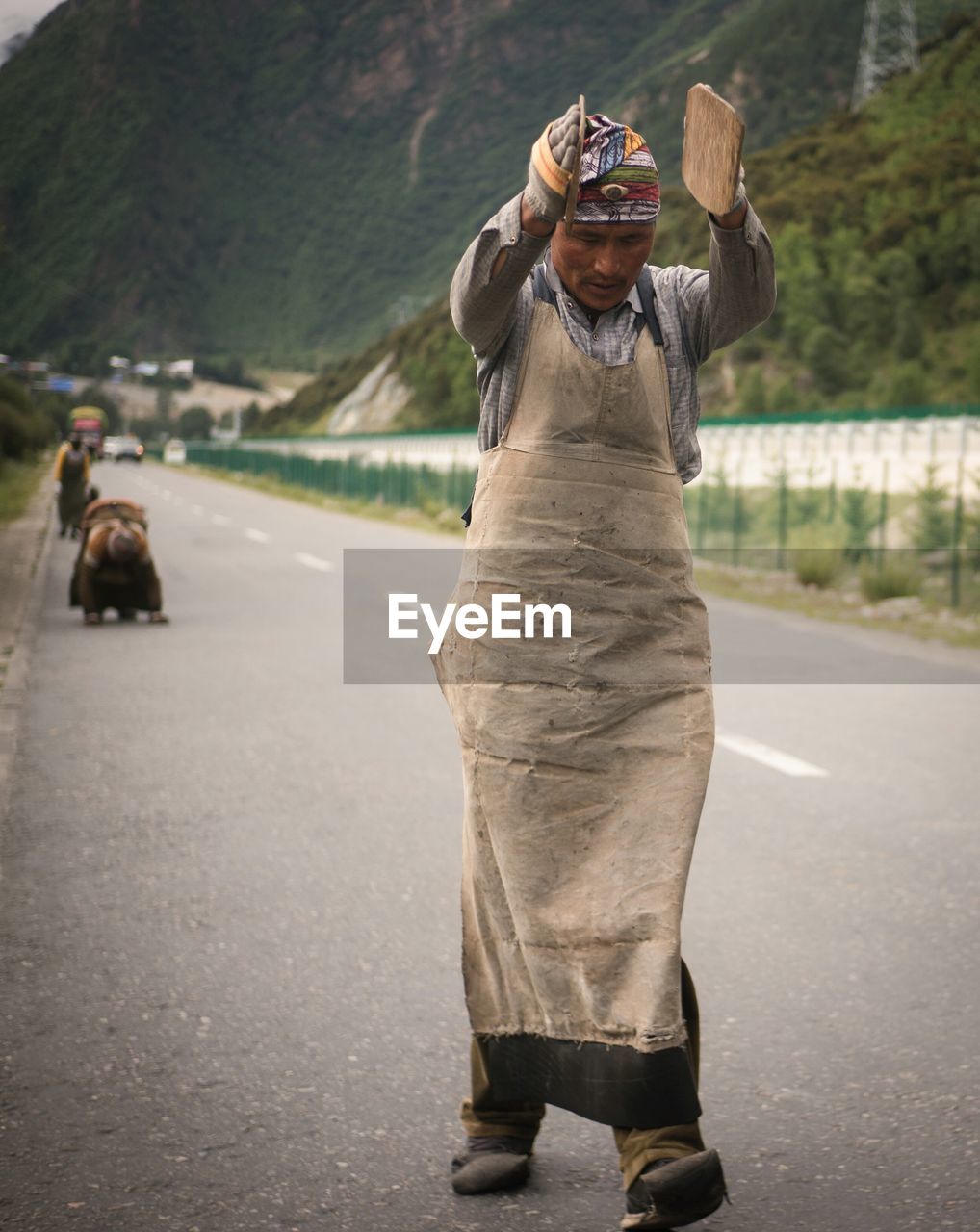 Mature man walking on road against mountains