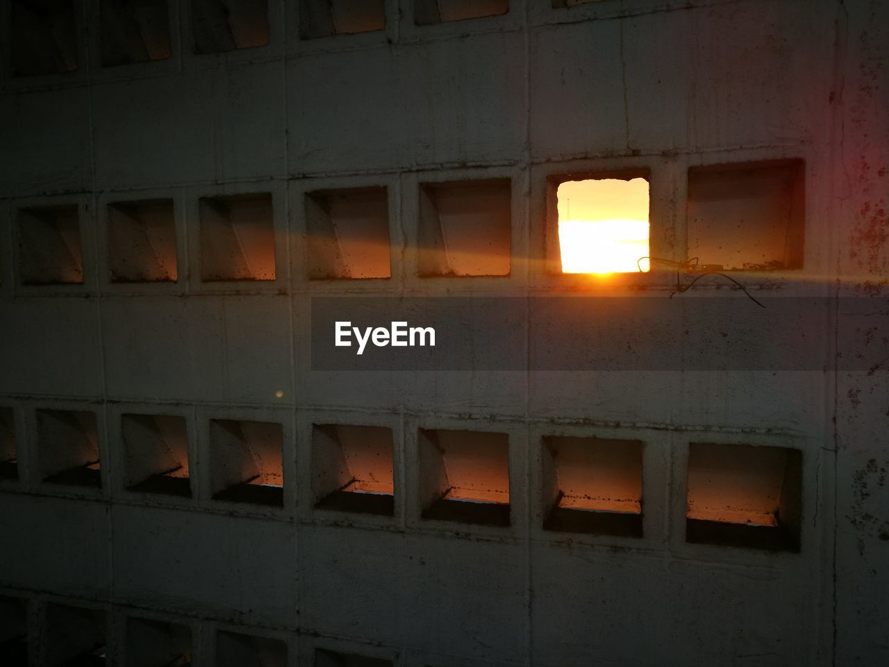 ILLUMINATED BUILDING SEEN THROUGH WALL