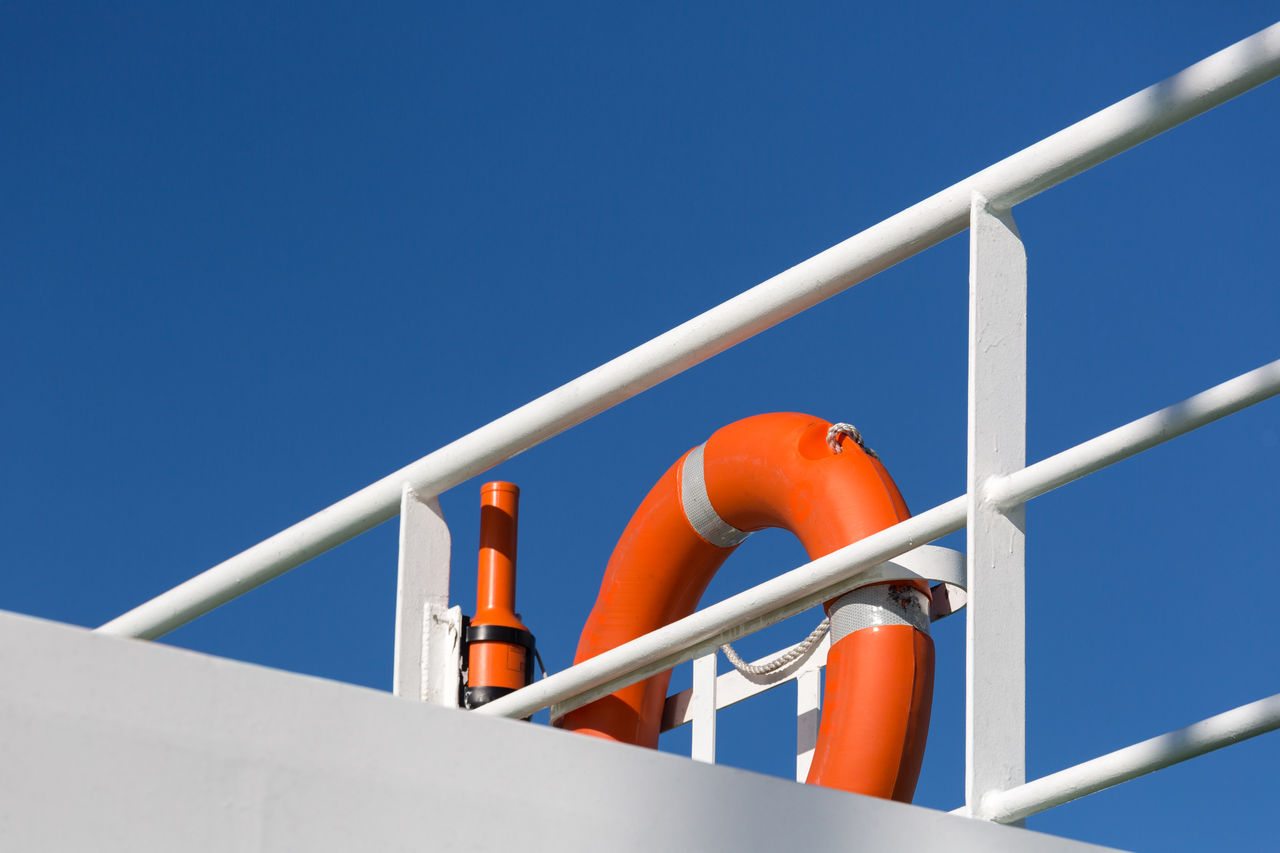 Close-up of inflatable ring at railing against clear sky