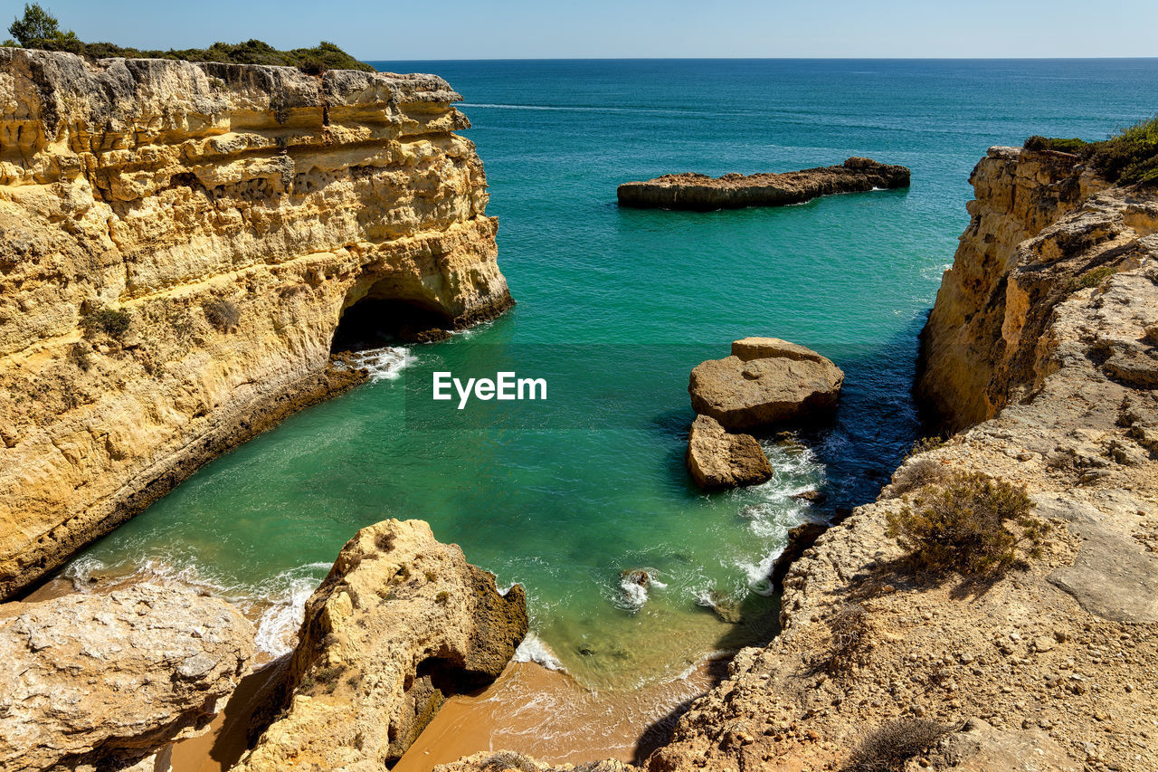 High angle view of rocks in sea against sky