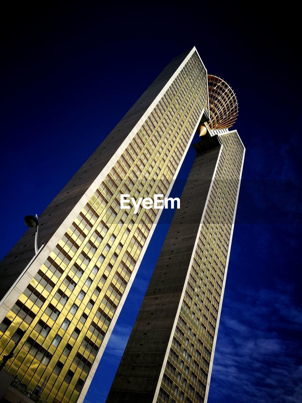 Low angle view of skyscrapers against blue sky