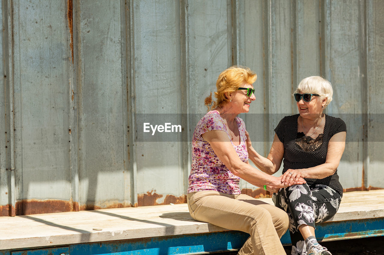 Two elderly women are happy to meet each other