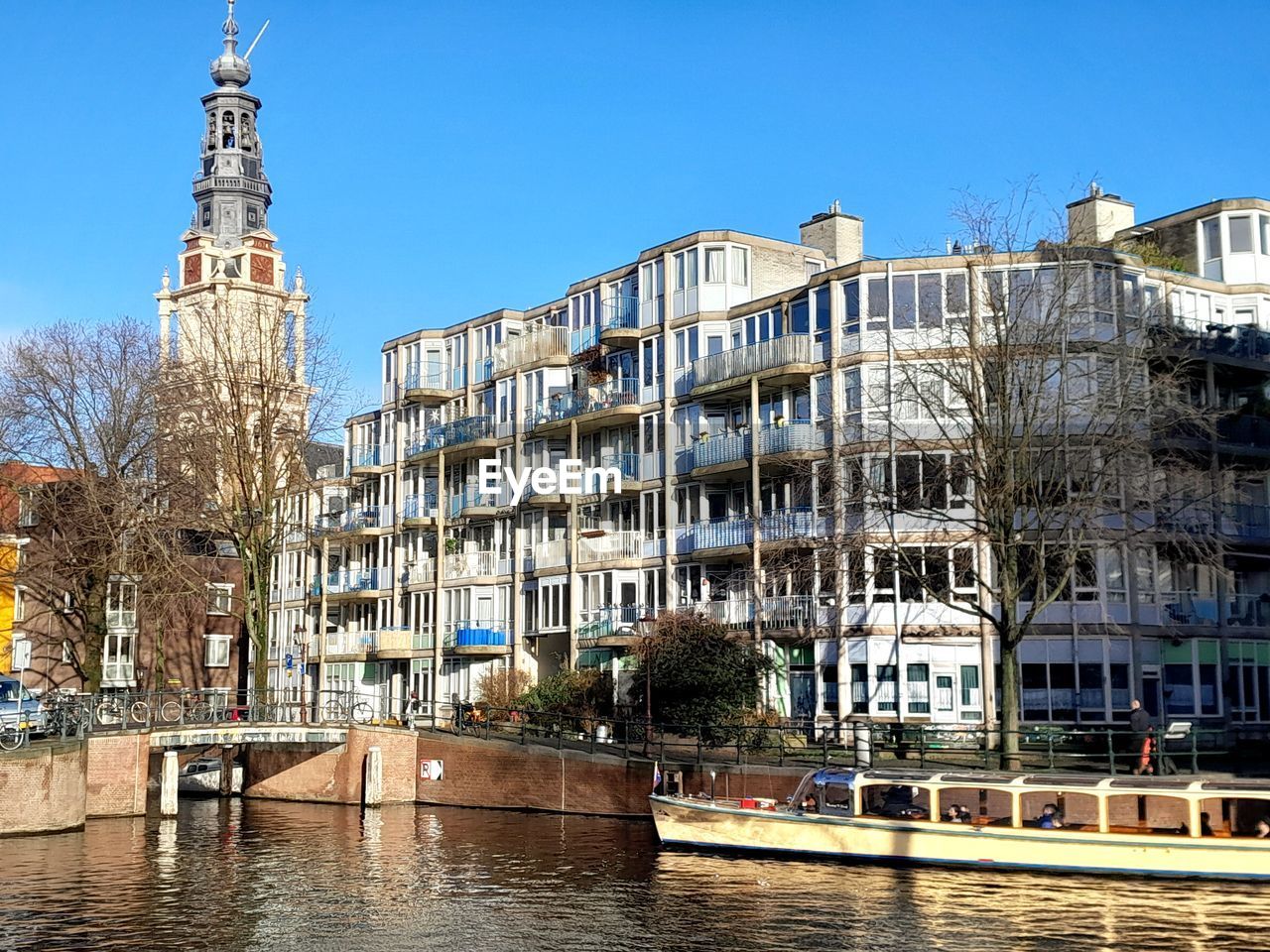 Church and canal in amsterdam on a sunny day