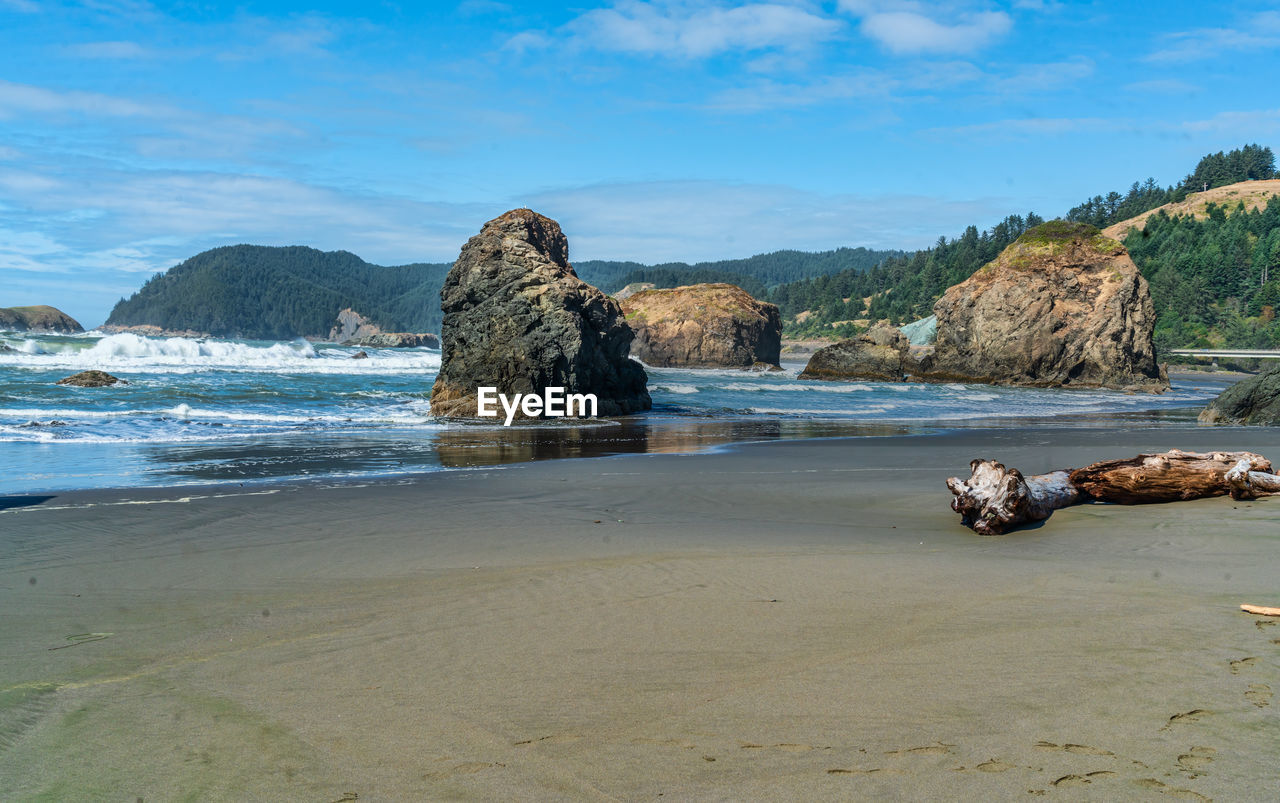 A view of meyers creek beach with waves and rock formations on the coast of oregon state.