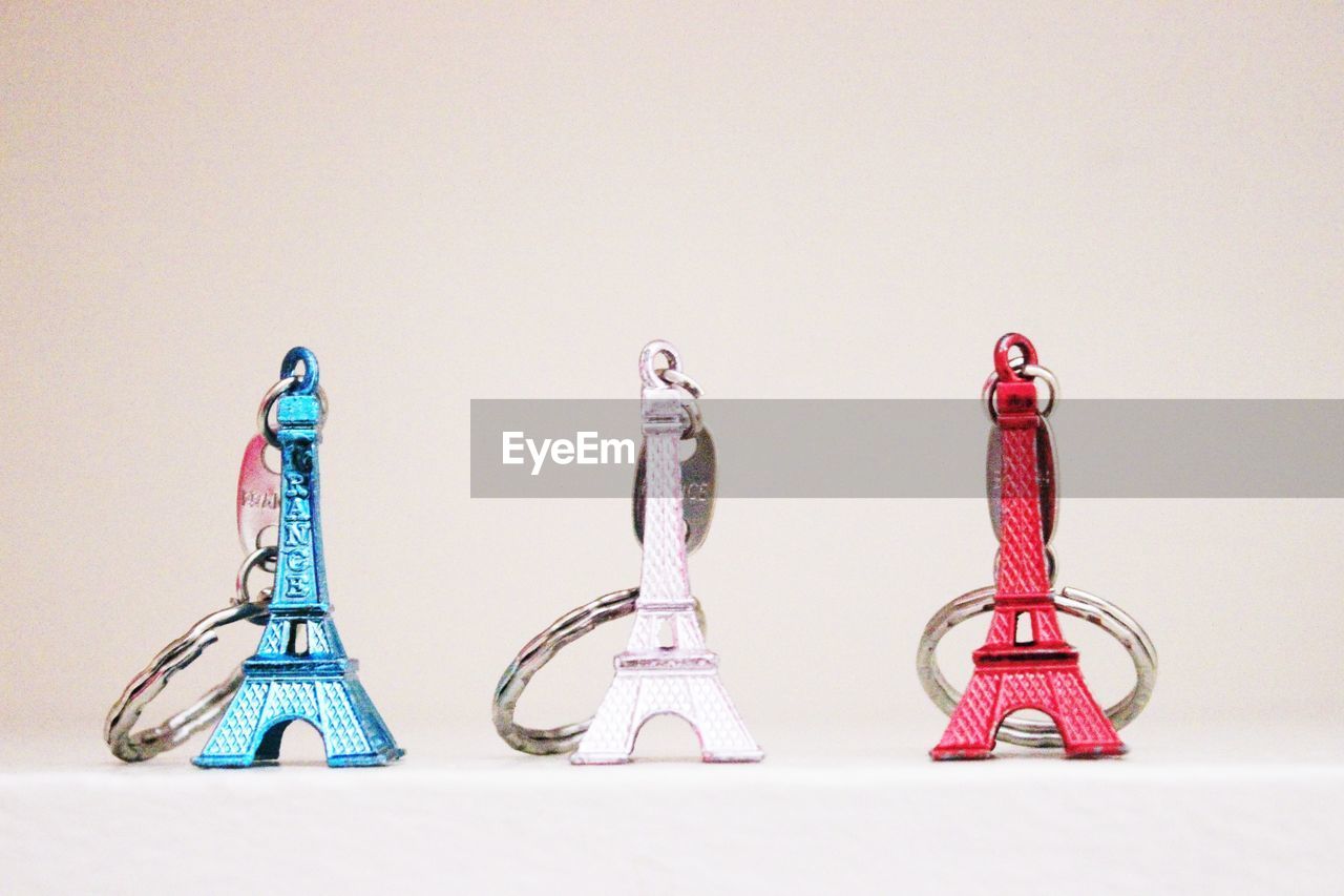 Eiffel tower shaped key chains against white background