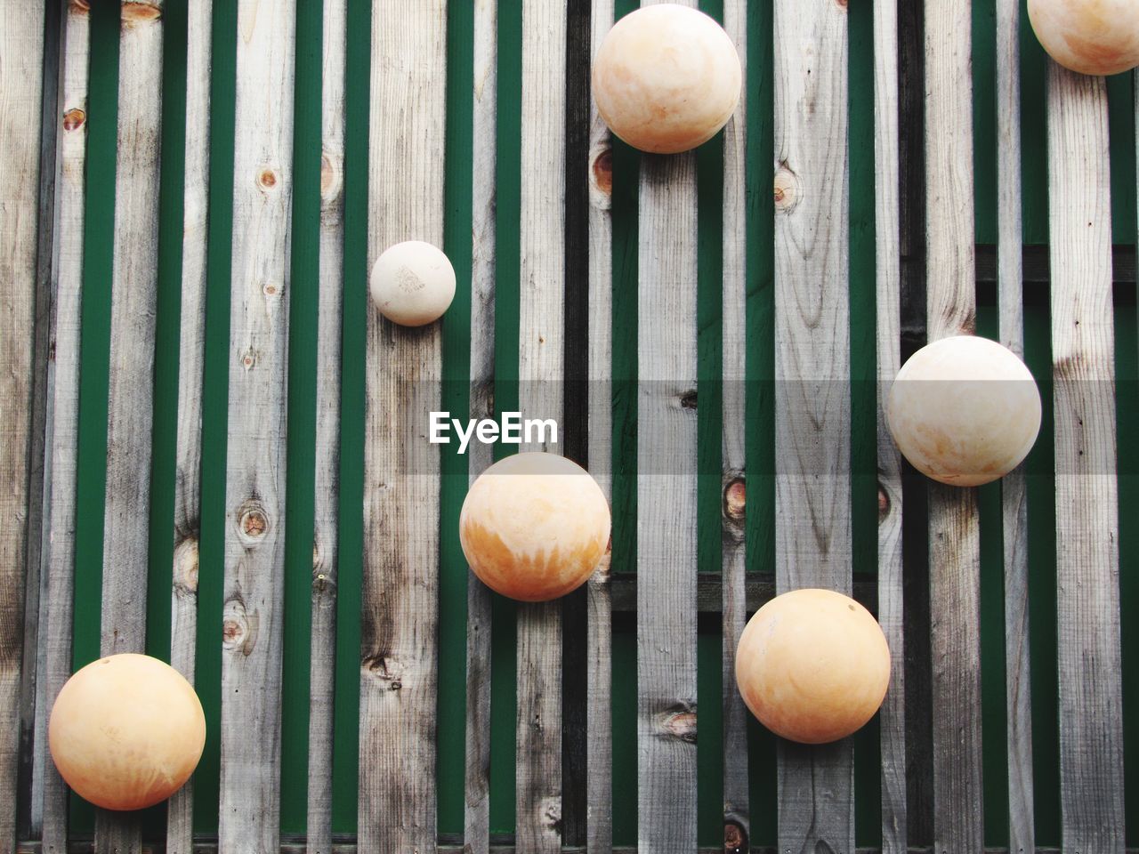 HIGH ANGLE VIEW OF PUMPKINS ON WOODEN STRUCTURE