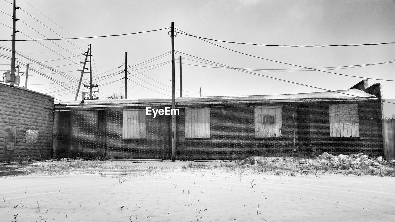 House with electricity pylons in winter season